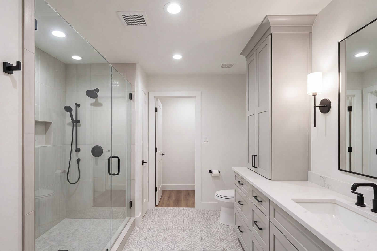 Burleson hall bathroom with a wide shower, tall storage and bright lighting